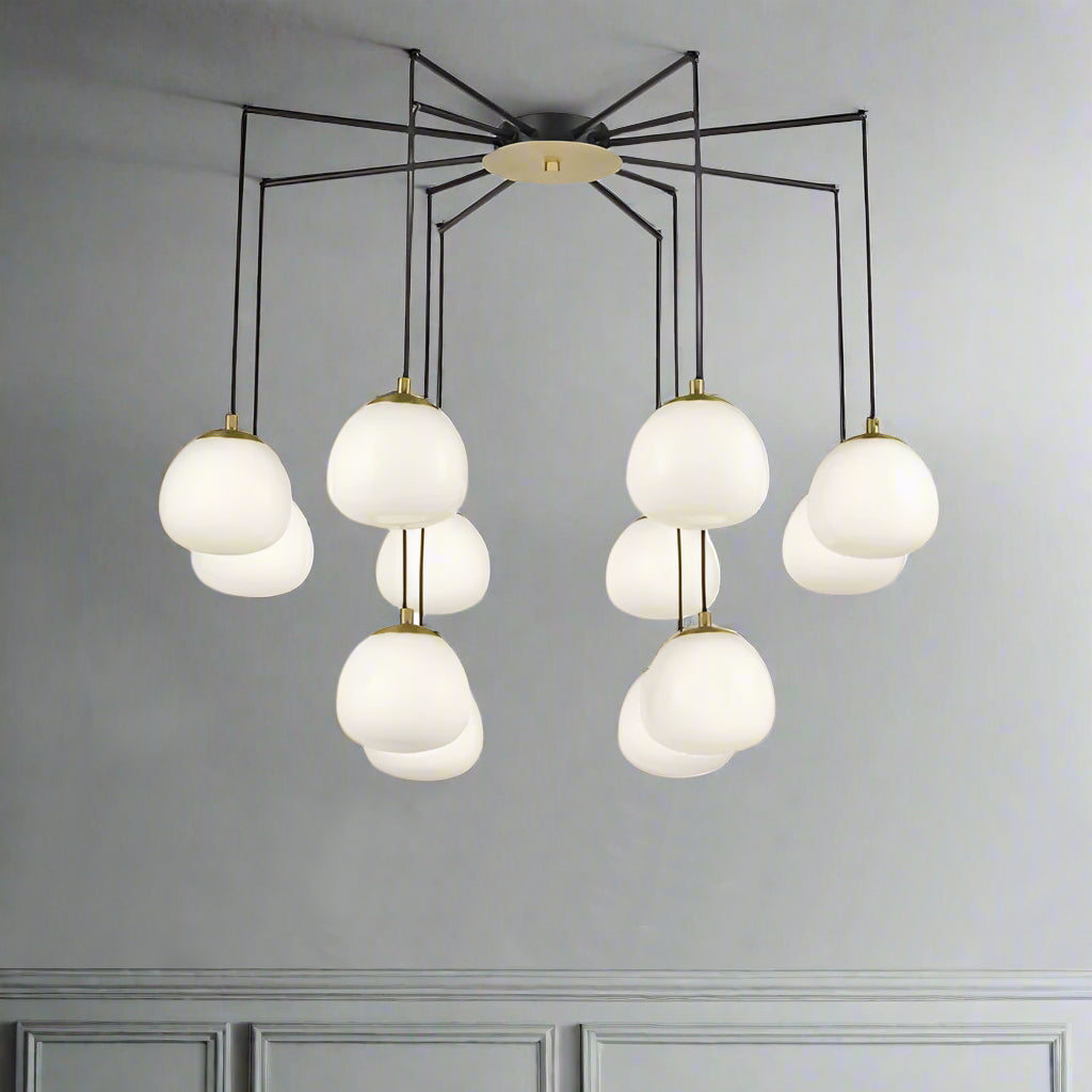 Total statement chandelier comprising 12 opal pendants on a beautifully structured matt black frame with brushed gold accents. Great design doesn't get much better absolutely stunning. A real spread of light from the spaced globes.