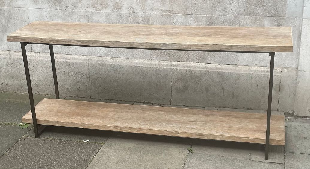 A really long wooden topped console table with useful bottom shelf. Set on a black iron frame. A fantastic hall or sitting room table for display and storage.  A striking piece that is so simple but would elevate any space in a contemporary or a period home. It has an open and airy design emphasizing functionality and clean lines and would look stunning in a hall with a large mirror. This table is now out of stock and we only have thei one left as a reduced price.
One remaining - REDUCED FROM £59