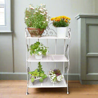 3 tier white folding shelf, great indoors or outdoors. With plants or books, this versatile little shelf can be placed anywhere, in any room, or folded neatly away when not in use.