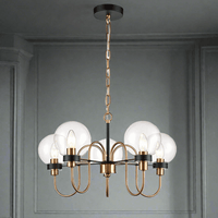 Five Clear glass globes on the five metal arms in antique gold on matte black, a stunning medium size statement light. Adjustable chain offers a long drop for this fitting. An extremely unusual fitting, suitable for a study, bedroom or smaller living room.