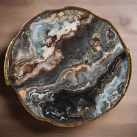 Dark, richly coloured agate tray in a brushed antique brass frame with 2 brushed brass handles. A really luxurious looking, substantial tray. 
This decorative tray is a simple yet impactful way to elevate your space. It offers both style and function, helping you keep things organized while also contributing to your home's aesthetic. Whether you're using it for displaying personal items, serving guests, or simply as a decorative piece, this beautiful tray can enhance the beauty and practicality of any