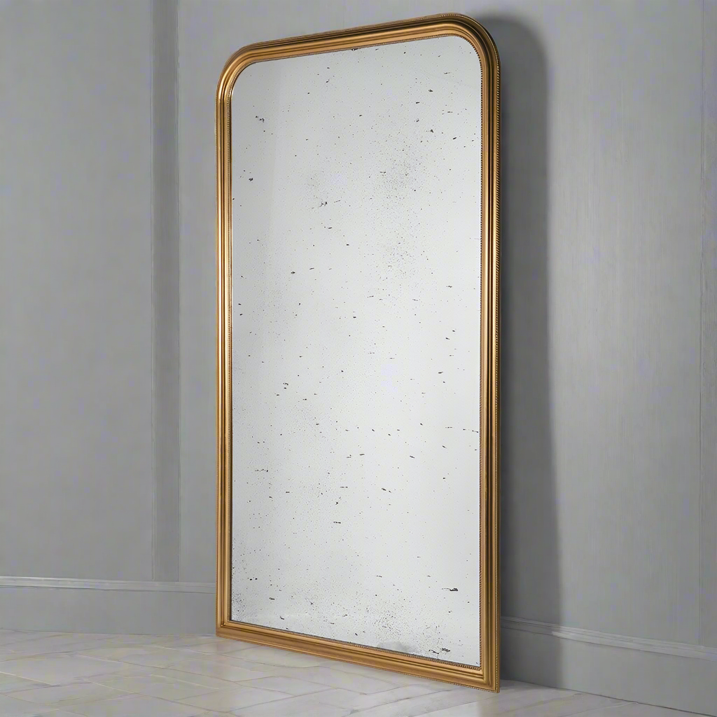 Massive gold beaded arched mirror with aged glass. A huge statement mirror, with a gold beaded arched frame enhanced by the vintage aged glass. Perfect hallway mirror, the soft reflection of the glass contrasting with the bright gilded frame. In a living room, to get a great vintage feel. Perfect in any space