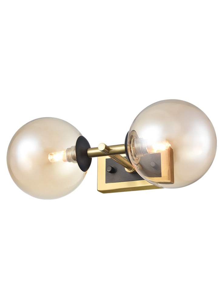 Stylish aged brass and matt black metal globe wall light  fixtures with two tinted glasses It creates an instant classy and elegant feel. With an IP Rating 44, this globe wall light can be use in the bathroom transforming your space with a glamorous look. Perfect bathroom lighting but globe wall lights look just as stunning in a hall or living room.