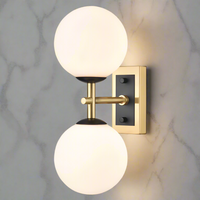 Stylish aged brass and matt black metal fixtures with two round opal glasses. It creates an instant classy and elegant feel. With an IP Rating 44, it can be use in the bathroom transforming your space with a glamorous look.
H: 30 cm W: 12 cm