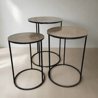 A set of three antique bronze top side tables on a metal iron base. A Simple but beautiful clean line. Can be purchased as a set or individually.