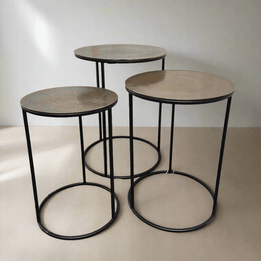 A set of three antique bronze top side tables on a metal iron base. A Simple but beautiful clean line. Can be purchased as a set or individually.