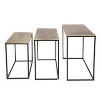 Set of three antique bronze top side tables of varying sizes on a metal iron base, displayed in a room setting.