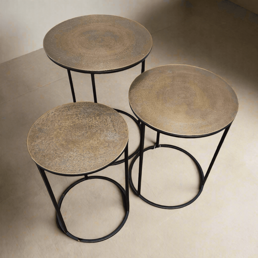 A set of three antique bronze top side tables on a metal iron base. A Simple but beautiful clean line. Can be purchased as a set or individually.
