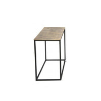 Set of three antique bronze top side tables of varying sizes on a metal iron base, displayed in a room setting.