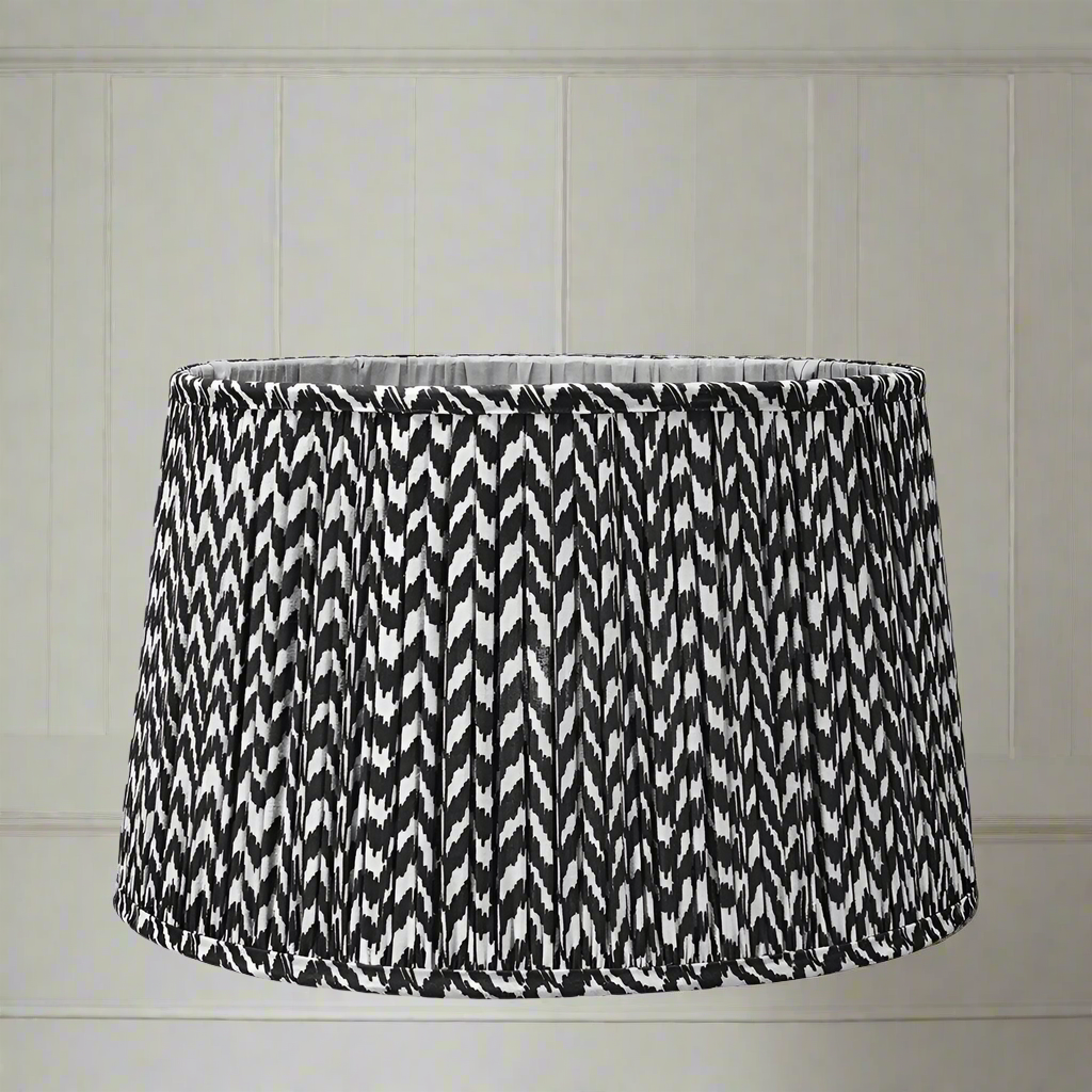 Beautifully patterned black and cream lampshade, pleated in a tapered shape. Pleated, tapered shades to add glamour to your table lights.