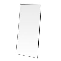 A simple and highly effective mirror minimalist in design yet maximum in impact.  With a super slim wooden black frame that is 2cm in depth, the striking thing about this mirror is the sheer volume of glass that reflects and bounces light back into your room.  Made in the UK, this mirror is worth the wait.  Also available in Gold.   H: 180 cm W: 90 cm D: 2 cm  Weight: 26 kg  Material: Wood  Made to Order with a lead time of 3-4 weeks. 