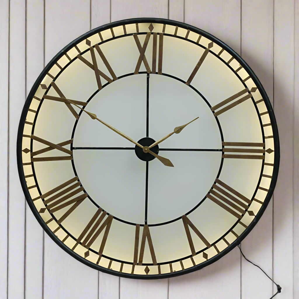 Available in two sizes 80cm and 120cm.  Depth 14cm.
This is an indoor clock where the hands are operated by two standard AA batteries.  The iron fascia and hands sit on top of a smoked glass.  The batteries are housed in the middle behind the hands - the cross section of which can be pulled out for access. 
An led strip light inside requires a power / three pin plug socket. 