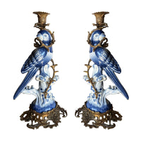 Bronze and porcelain parrot candle holders, exquisite reproduction of the Georgian originals.   Beautifully made with the exquisitely coloured porcelain parrots sitting on a very ornate swirl base of bronze, a bronze metal twist to the body of the parrot and topped with a bronze candle holder.  A great addition to a country house interior or a period city home. The perfect gift for people who have everything. Evoking a bygone age but with the colour and patina to work in any interior, these b