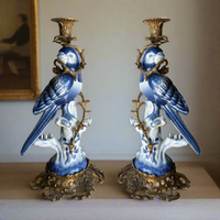 Bronze and porcelain parrot candle holders, exquisite reproduction of the Georgian originals.   Beautifully made with the exquisitely coloured porcelain parrots sitting on a very ornate swirl base of bronze, a bronze metal twist to the body of the parrot and topped with a bronze candle holder.  A great addition to a country house interior or a period city home. The perfect gift for people who have everything. Evoking a bygone age but with the colour and patina to work in any interior, these b