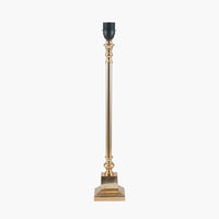 A tall, slim brass metal table lamp base with a square platform and a socket for a bulb on top.