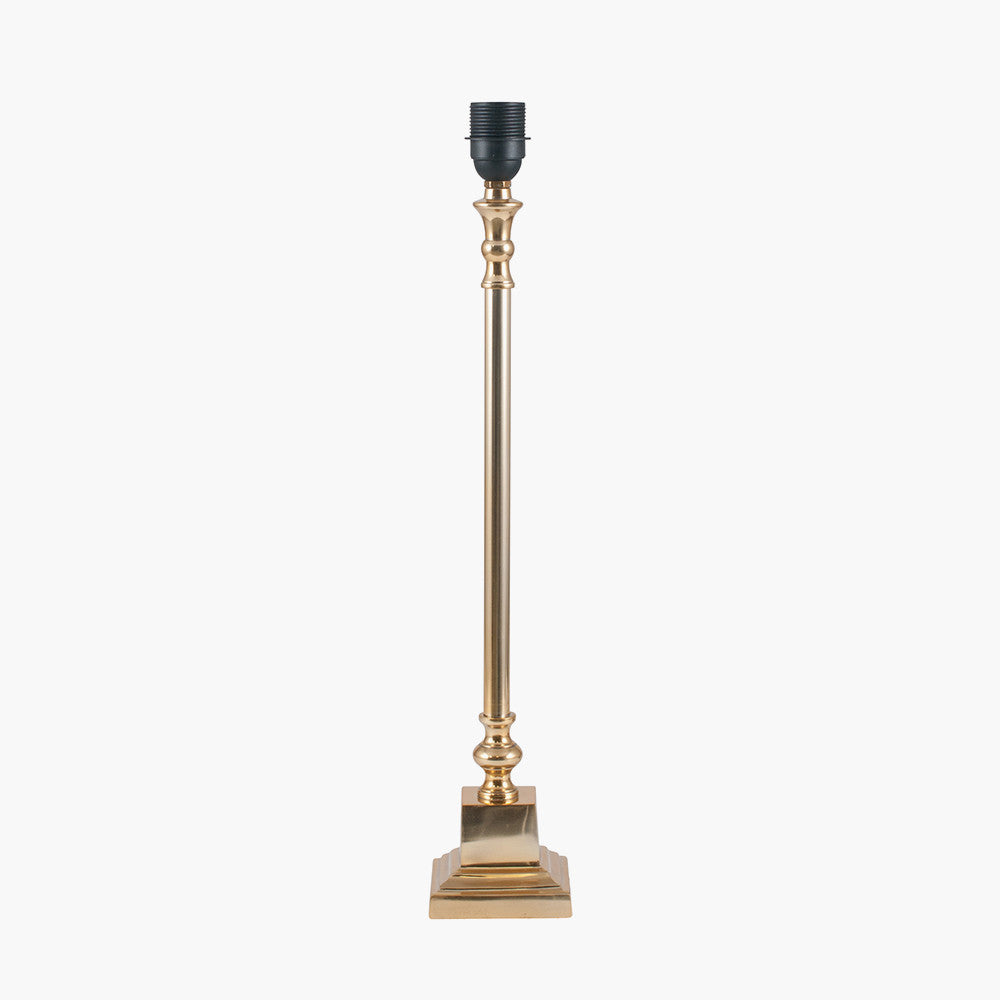 A tall, slim brass metal table lamp base with a square platform and a socket for a bulb on top.