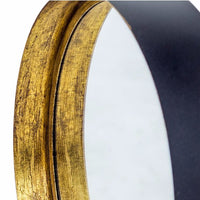 Close-up of a bronze deep frame mirror showcasing the textured gilt finish and sleek black backing.