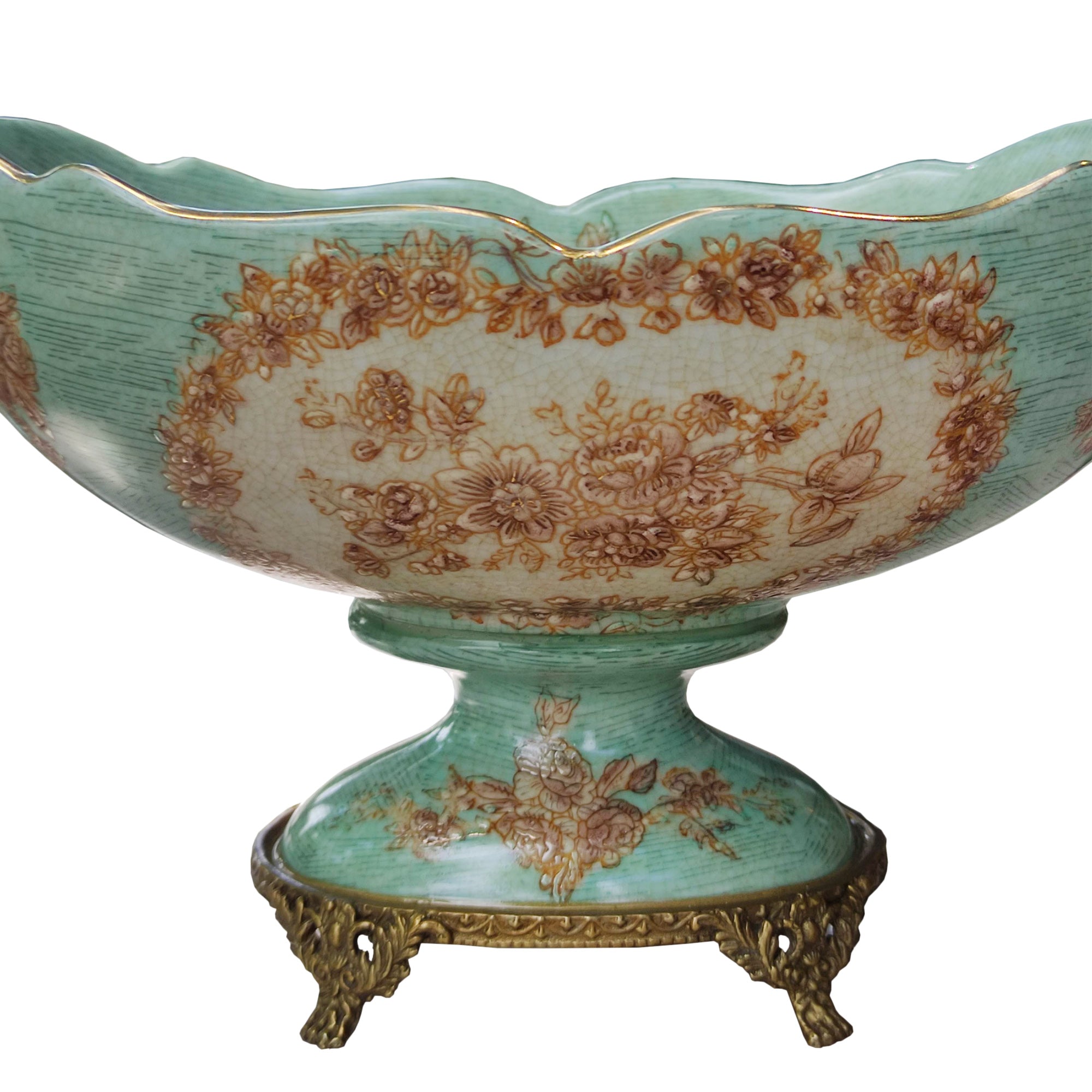 Lift your table decor with our stunning Bronze Cherub Porcelain Bowl, an heirloom piece and a masterpiece of craftsmanship and elegance. This beautiful bowl features intricate bronze cherubs adorning each end, resting delicately on tiny bronze feet. 
Designed to impress, this bowl is more than just a functional piece—it's a work of art. The sloping scalloped edge adds a touch of sophistication, making it perfect for displaying fresh blooms, or even a bountiful arrangement of fruit. Measuring 32 cm in