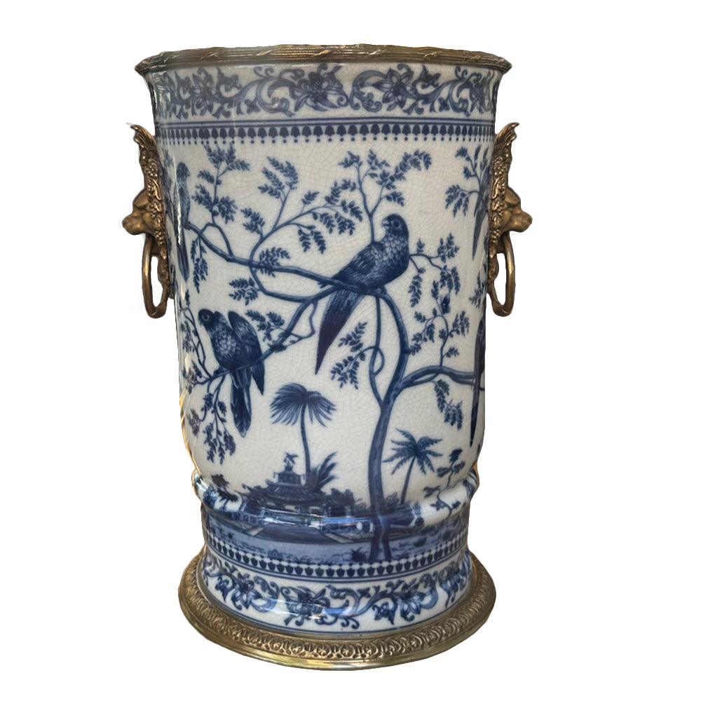Handcrafted in superior blue and white porcelain, this delicately weighted vase features intricate bird and foliage motifs.  Bold bronze lion head handle, detailed bronze accents reflect exceptional craftsmanship.  
Ideal for living rooms, entryways, or as a centerpiece, this handcrafted vase is designed to be  a lasting beauty, heirloom piece.  
H: 33 cm W: 27 cm D: 24 cm 
Materials: Bronze and Porcelain