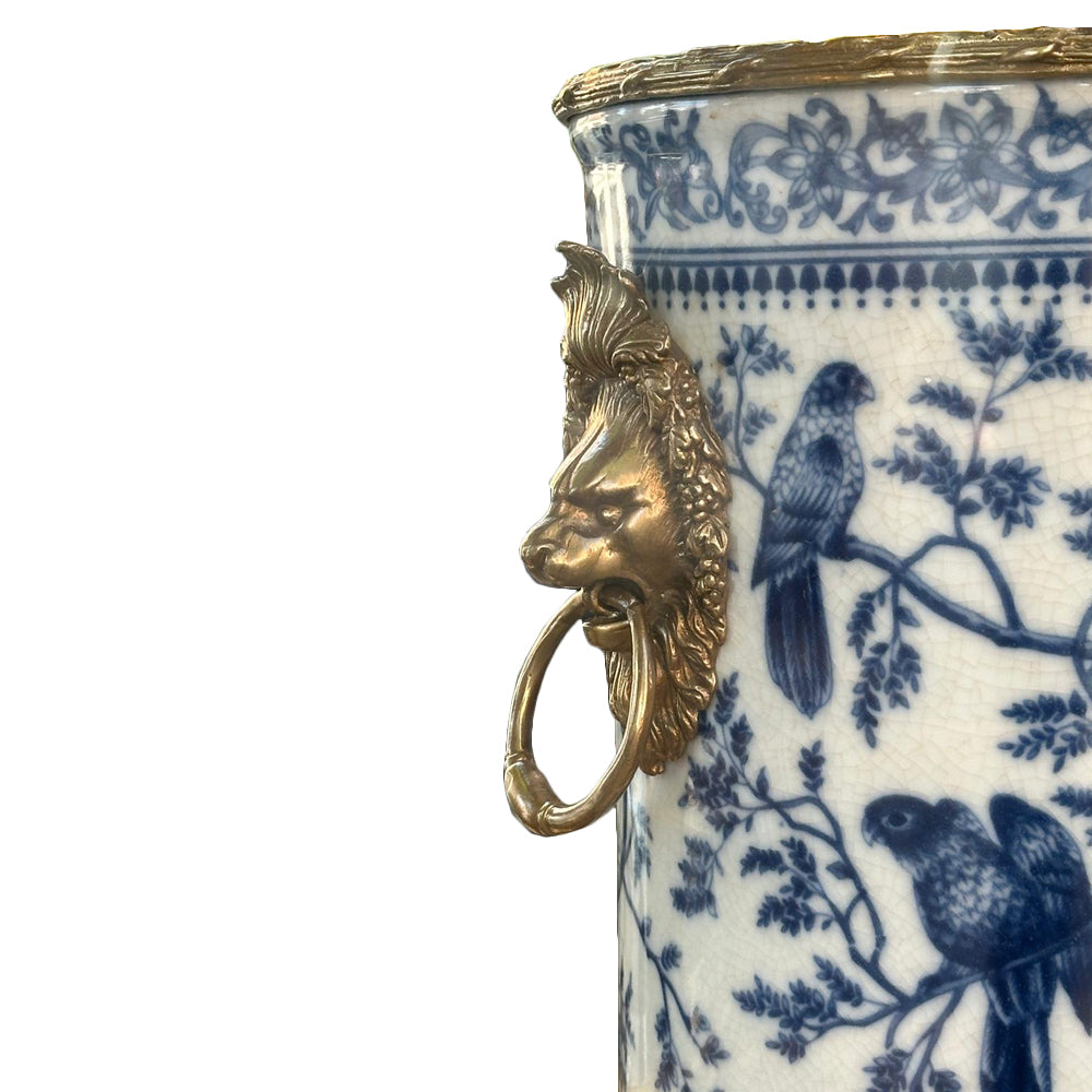 Handcrafted in superior blue and white porcelain, this delicately weighted vase features intricate bird and foliage motifs.  Bold bronze lion head handle, detailed bronze accents reflect exceptional craftsmanship.  
Ideal for living rooms, entryways, or as a centerpiece, this handcrafted vase is designed to be  a lasting beauty, heirloom piece.  
H: 33 cm W: 27 cm D: 24 cm 
Materials: Bronze and Porcelain
