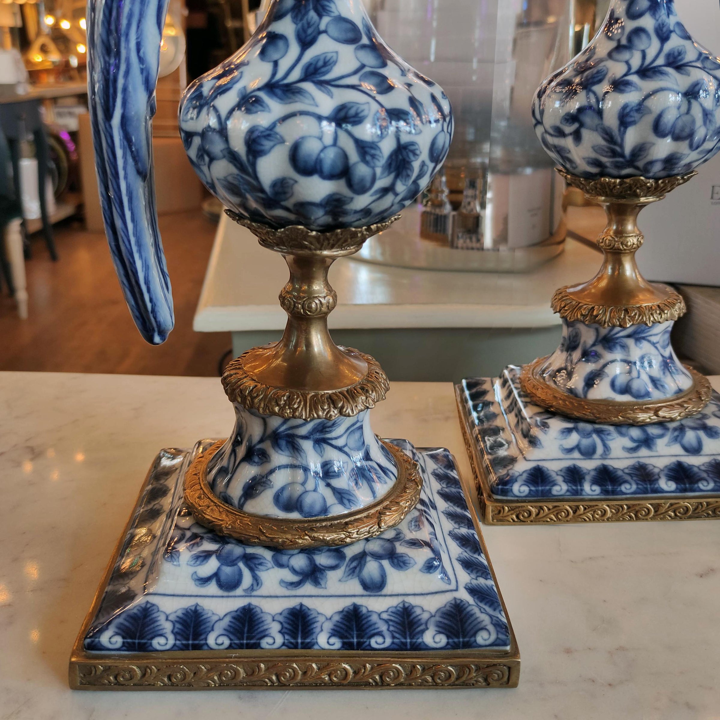 Blue and white ceramic lamps with gold accents on a marble surface.