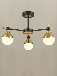 A three brushed gold and opaque glass globe light.  Semi-flush on a back and gold metal fixture creating stunning mix of colours for both contemporary and classic settings.  W: 45 cm  H: 29 cm  Requires 3 x G9 Bulbs.