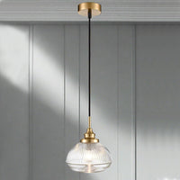 A ribbed glass pendant on beautifully designed brushed brass fittings. An unusual ribbed glass pendant on brushed gold metal with black flex, perfect hall, living room or kitchen light.
W: 18 cm H: 32 cm 