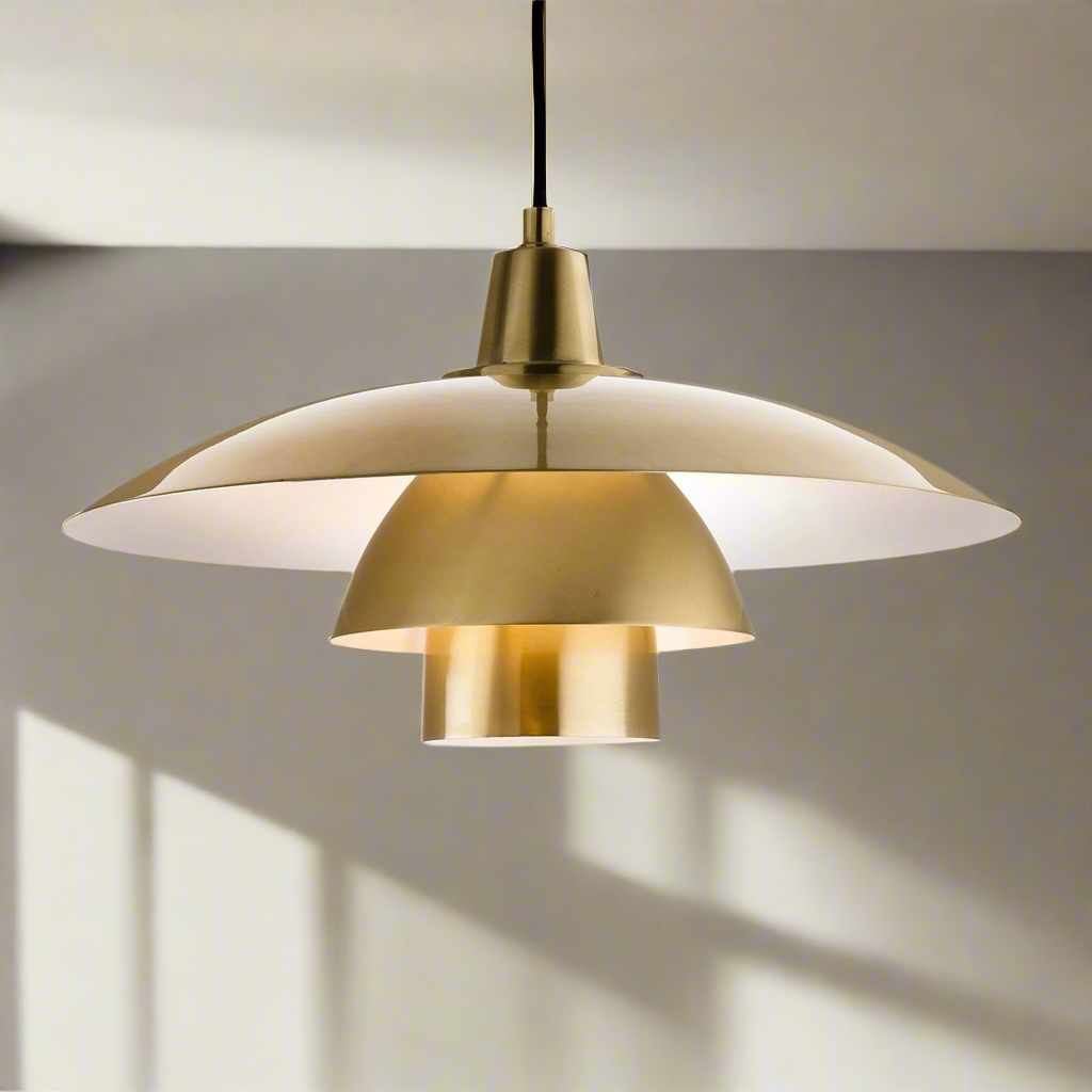 A brushed brass metal pendant light with a contemporary design, featuring a dome shape and a black cable.