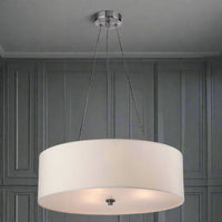 A brushed steel pendant light with a cream shade, suspended by three adjustable wires, with a frosted base diffuser.