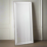 A full length Venetian mirror with bevelled frame set in a slim gilt wood.