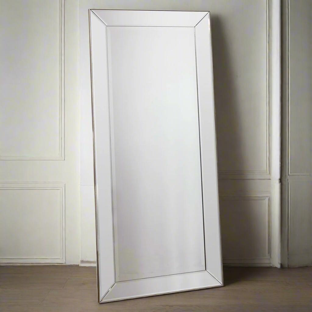 A full length Venetian mirror with bevelled frame set in a slim gilt wood.
