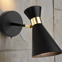Matt black & brass conical shaded wall light with a swith on the backplate.