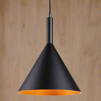 A conical metal pendant light with a gold/white inner, hanging from a ceiling on a wooden surface.