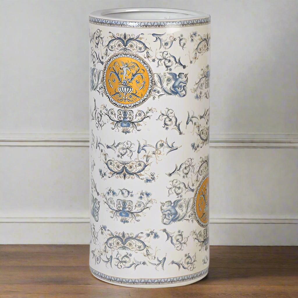Classic scene ceramic umbrella stand. Cherubs, swags, swirls and garlands decorate this charming umbrella stand which would look 'heavenly' in your hall.  In a pretty pale grey/blue colour with gold highlights, colours that will fit in any decor.
