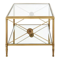 Empire style gilt metal and glass coffee table with metal cross medallion ends. This classic table will work well in a traditional or ultra contemporary setting. The mixture of the gilt metal and glass makes for a beautiful light and airy yet substantial piece of furniture.