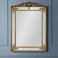 Exceptionally stunning statement mirror in gold, with beveled glass panels, gilt crown and corner gilt appliques. A giant mirror which will brighten and lighten any room.  A classic gilt finish with corner motifs and long crested top just add to the antique luxury feel of this mirror,