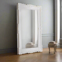 A large classic ornate white mirror to fill a entire wall and bring light and space into a room. Heavy, decorative famed 'Louis' style mirror.