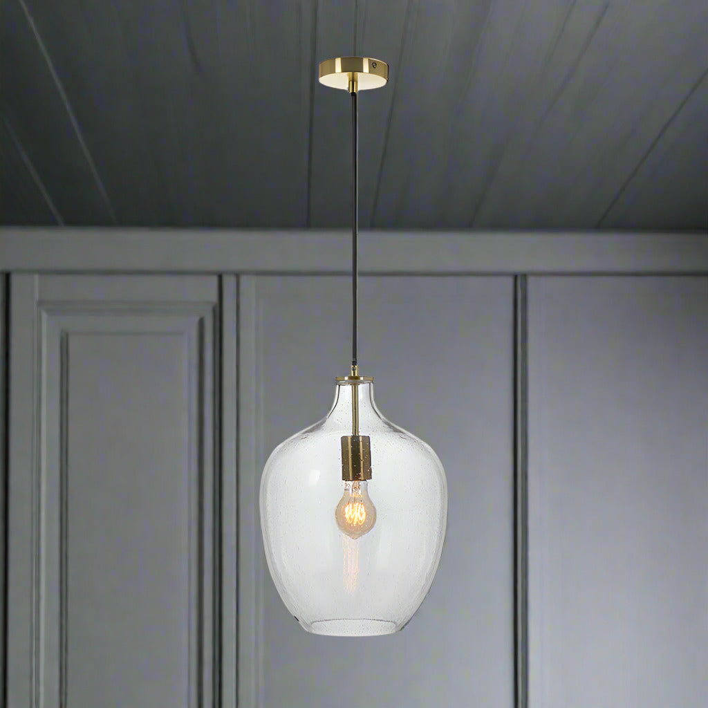 Glass pendant with subtle bubble effect to the glass and pale gilt metal accents. Large enough for any room giving a stunning glow when teamed with a filament bulb.