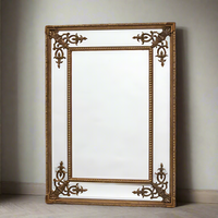 Tall, slim paneled mirror with decorative corner motif. Exceptionally elegant mirror - the beveled glass panels reflecting light in any room.  A exceptionally glamorous mirror which lifts the decor in any room adding a luxurious feel as well as lighting up the room.  We have a range of ornate mirrors in the Chiswick, West London store.