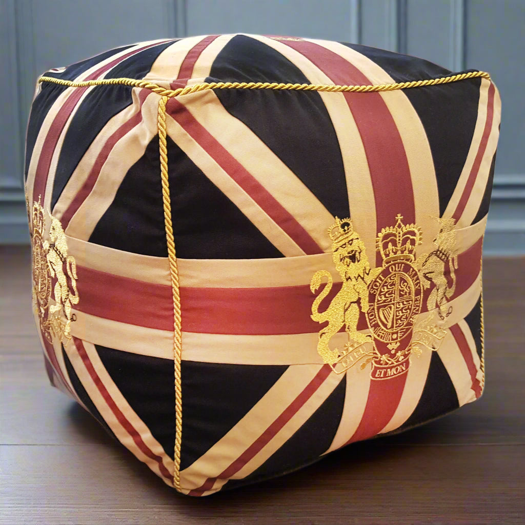 A Union Jack crested cube pouffe.  This stool is structured with a firm seat and great as an extra seat or footstool. An iconic design which will add a decorative edge to your interiors. Exceptional piece of furniture.