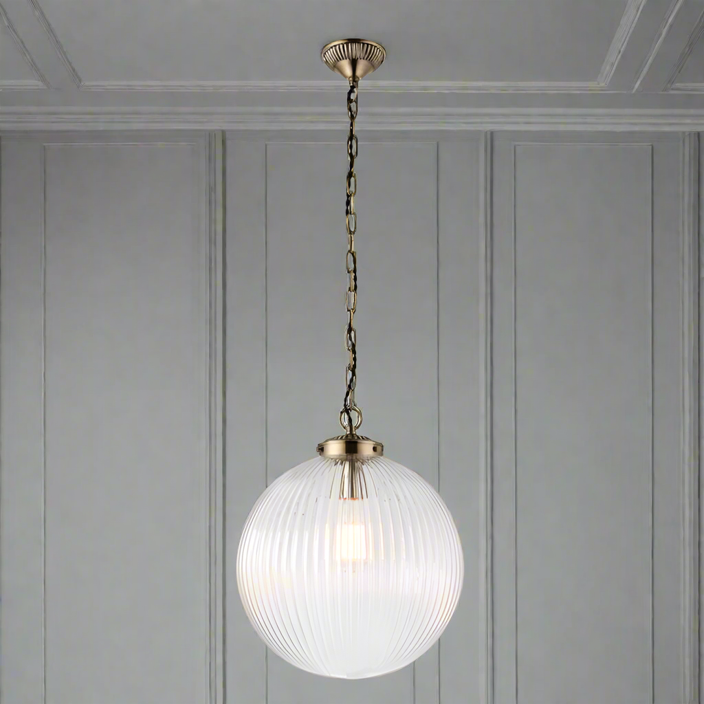 This oversized ribbed glass pendant with antique brass finish will add a simple but elegant feel to any hall or stairwell, a simple design but on a large scale. The addition of a warm filament bulb you will create the perfect ambience.