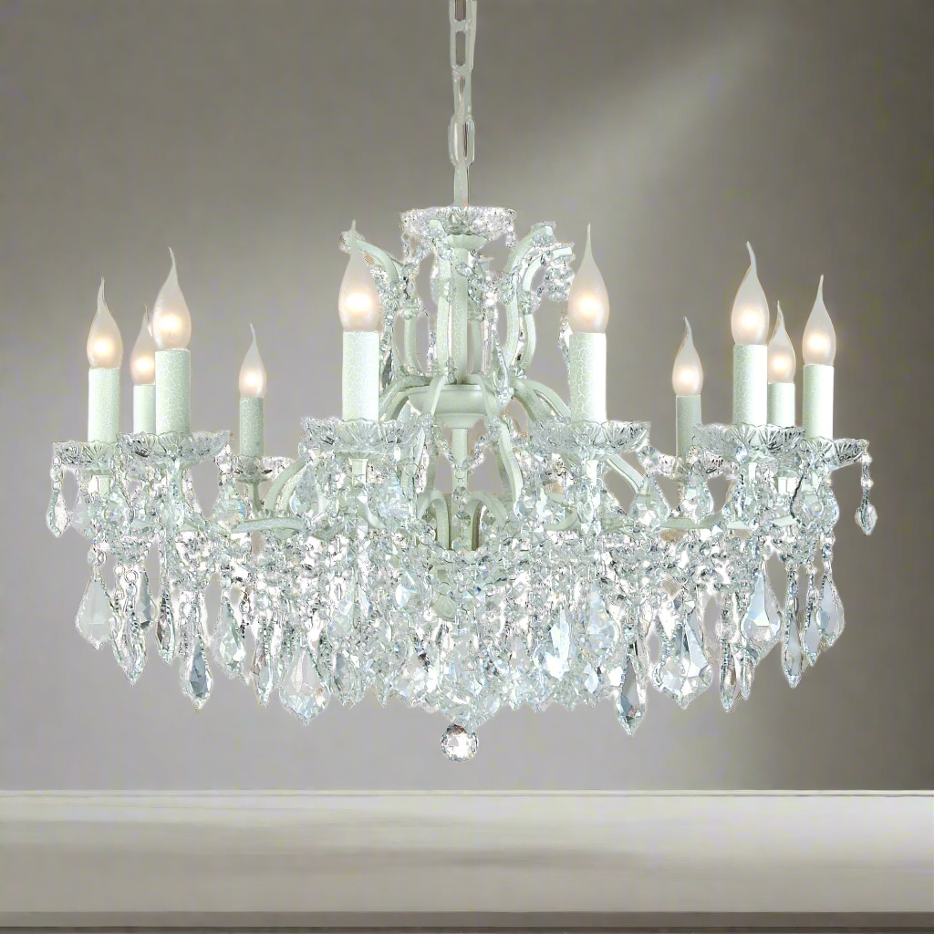 Large, 12 arm classic white metal chandelier, smothered in crystal drops a classic look for a contemporary room, adding a mass of light from the twelve bulbs. Perfect period home lighting.