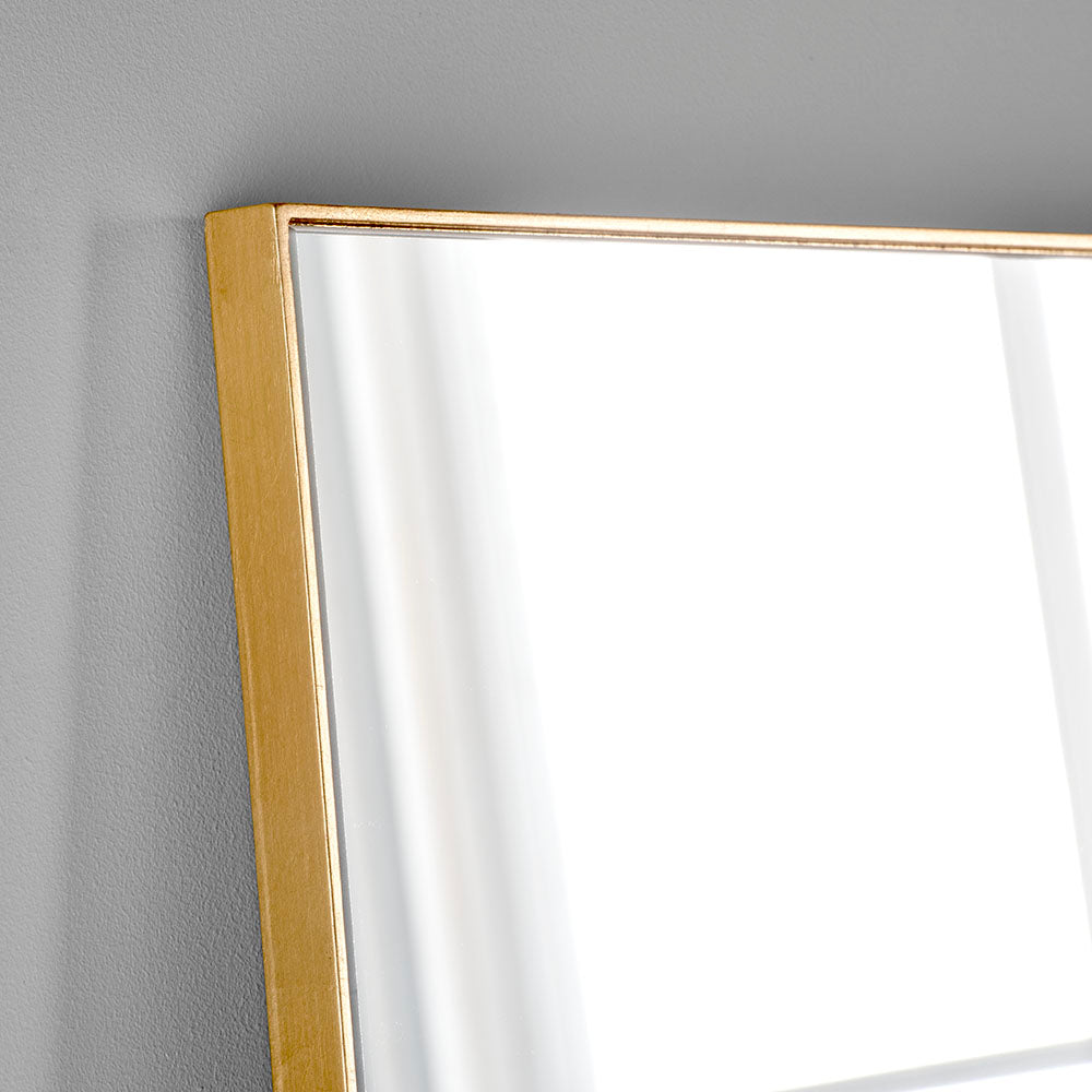 A simple and highly effective mirror minimalist in design yet maximum in impact.  With a super slim wooden gold frame that is 2cm in depth, the striking thing about this mirror is the sheer volume of glass that reflects and bounces light back into your room.  Made in the UK, this mirror is worth the wait.  Also available in black.   H: 180 cm W: 90 cm D: 2 cm  Weight: 26 kg