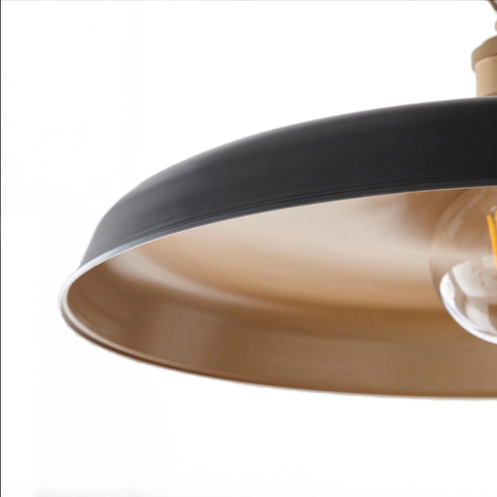 Modern pendant featuring a matt black finish in a chain. This wide disc pendant light is a striking, contemporary lighting fixture that combines sleek design with industrial charm. Its wide shape and the inner gold allows the soft light to spread evenly across any room. It is a very stylist and ideal for living rooms, bedrooms and kitchens