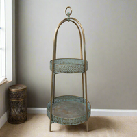 A unique and very pretty shelf unit with pierced metal detailing around the shelves which can be lifted out and also used as trays.  Finished in a rustic antique gold colour, this metal unit has two shelves encased in an outer frame that can fold flat.  