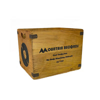 Two wooden storage crates with 'Mountain Records' branding on them, one large and one medium, both with metal handles.