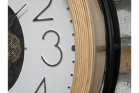A large moving cog clock with white enameled face and pale wooden surround. The entire cog clock is encased in a iron frame. A statement clock which will enhance any wall