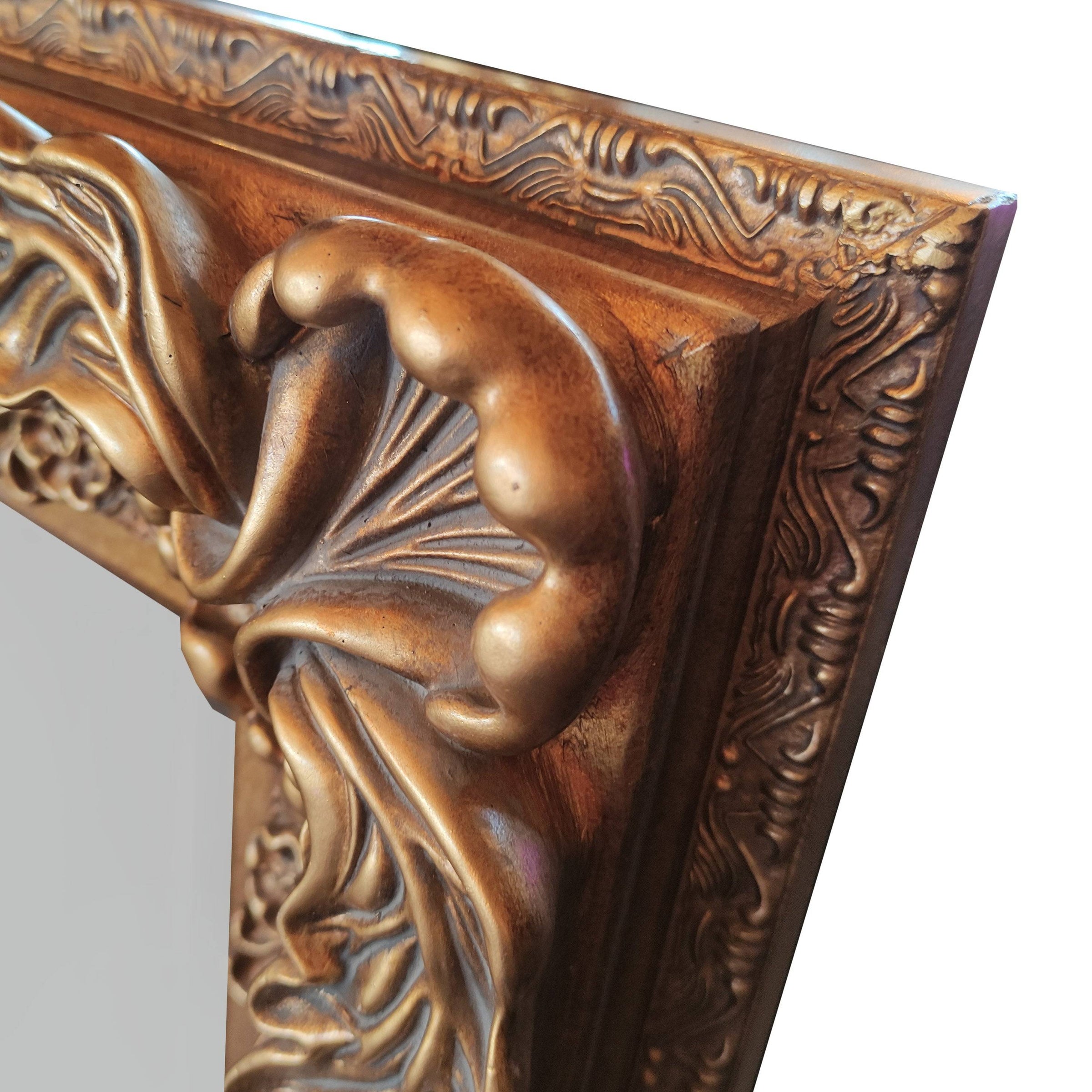 Ornate, burnt gold mirror, great overmantle size, can be placed vertically or horizontally. Classic carved frame to add a touch of opulence to any wall.
