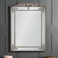 Stunning, huge silver gilt panelled mirror, a really grand piece for your wall. The bevelled edges on each of the panels flashing light into the room. A traditional massive mirror with a twist has an ornate crown and decorative swirls at each corner to emphasise  the four paneled edges. Over a fireplace, in a bedroom or a hall, it will just add space and light.
H: 192 cm W: 134 cm D: 6 cm