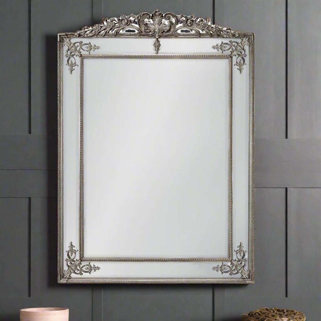 Stunning, huge silver gilt panelled mirror, a really grand piece for your wall. The bevelled edges on each of the panels flashing light into the room. A traditional massive mirror with a twist has an ornate crown and decorative swirls at each corner to emphasise  the four paneled edges. Over a fireplace, in a bedroom or a hall, it will just add space and light.
H: 192 cm W: 134 cm D: 6 cm